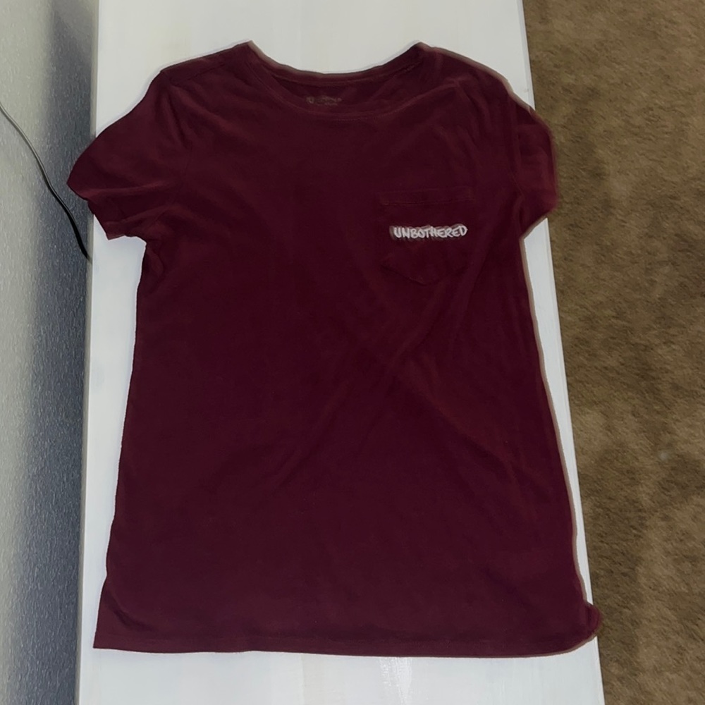 Maroon shirt in size adult small with the words unbothered on it